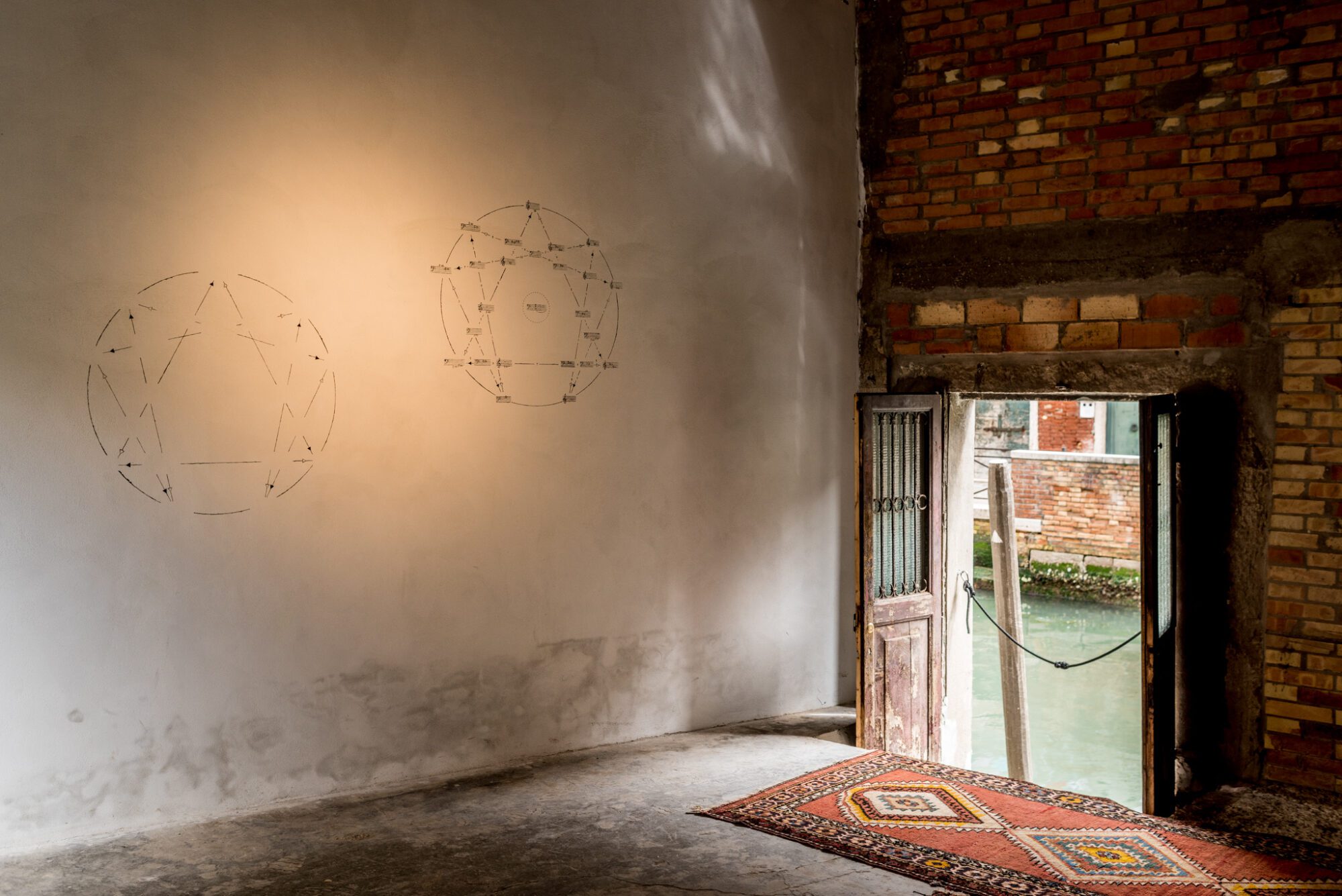 An installation view of Andrius Arutiunian piece with the score frescoed at Venice Biennale